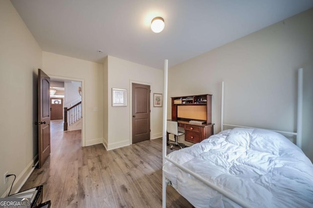 bedroom featuring baseboards and light wood-type flooring