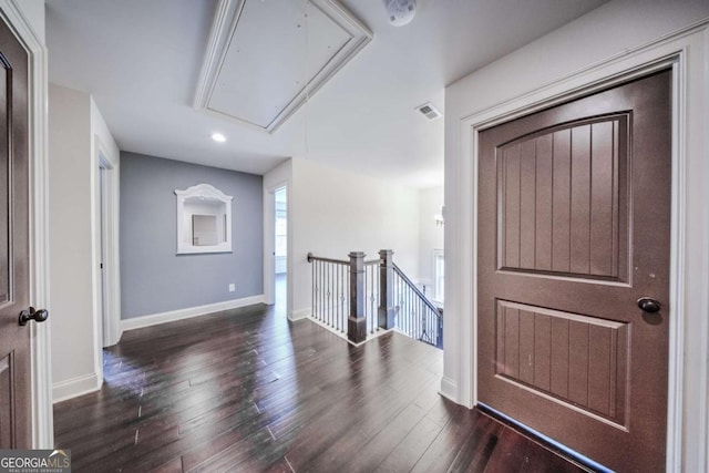 foyer entrance featuring visible vents, wood finished floors, and baseboards