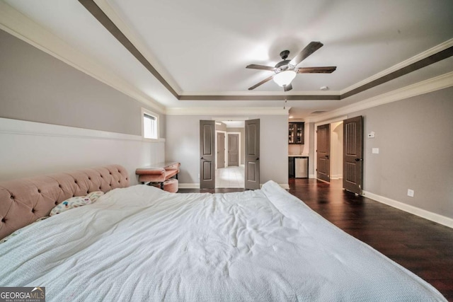 unfurnished bedroom featuring baseboards, a raised ceiling, dark wood finished floors, and ornamental molding