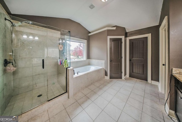 bathroom featuring vanity, a stall shower, tile patterned flooring, vaulted ceiling, and a bath