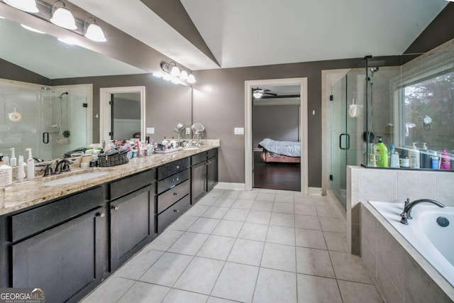 full bathroom with tile patterned flooring, a sink, and vaulted ceiling