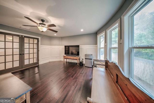 sitting room featuring visible vents, wood finished floors, french doors, a decorative wall, and ceiling fan