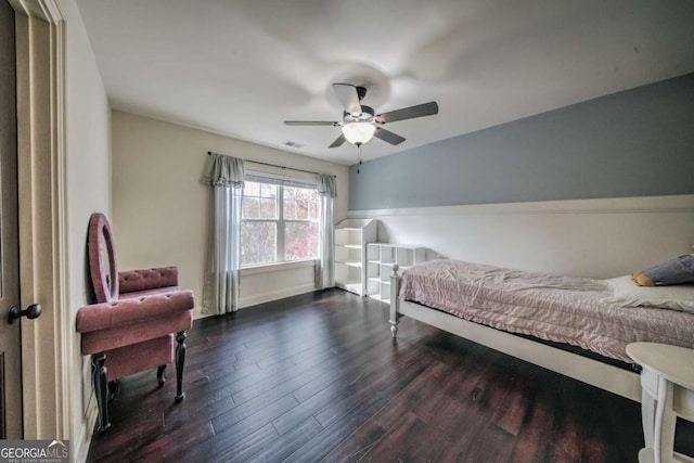 bedroom featuring dark wood-type flooring, a ceiling fan, and visible vents