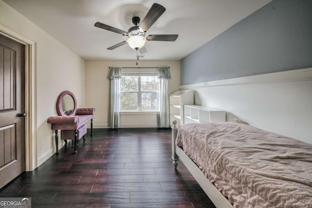 bedroom featuring ceiling fan, baseboards, and wood finished floors