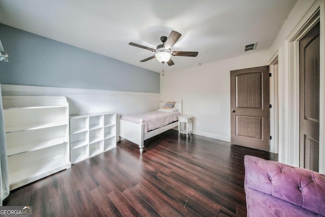 bedroom with ceiling fan, visible vents, baseboards, and wood finished floors