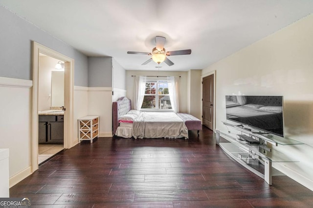 bedroom featuring connected bathroom, baseboards, ceiling fan, and wood-type flooring