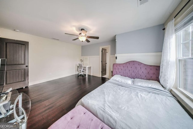 bedroom featuring a ceiling fan, wood finished floors, and visible vents