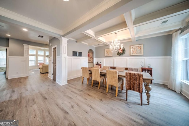 dining room featuring coffered ceiling, beam ceiling, decorative columns, light wood-style floors, and wainscoting