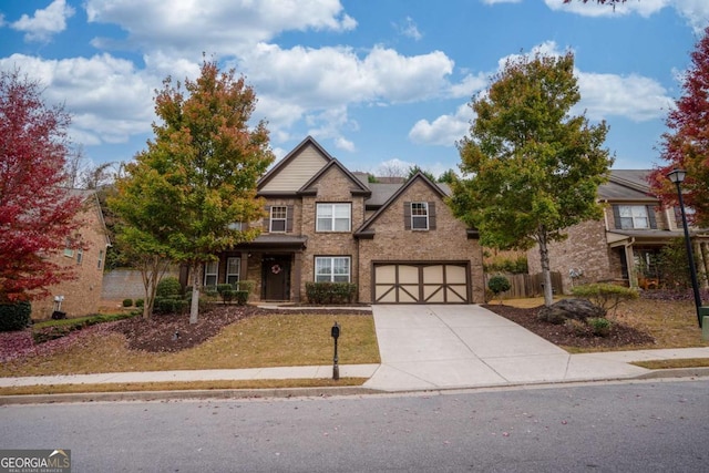 view of front facade featuring brick siding, driveway, and a garage