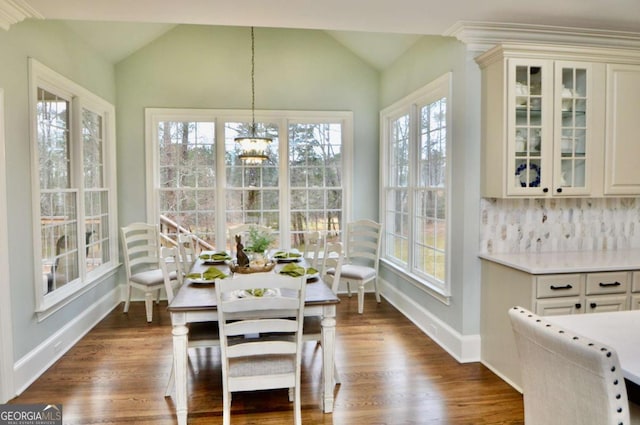 sunroom / solarium featuring a notable chandelier and vaulted ceiling