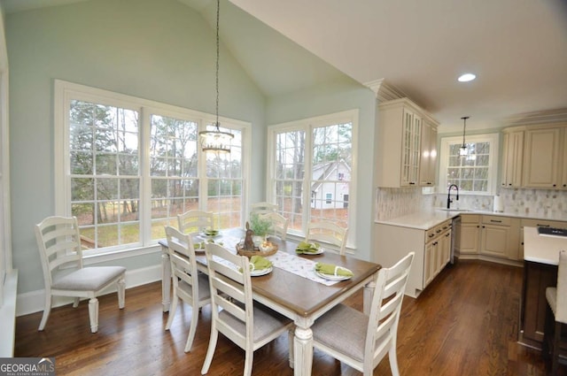 dining room with dark wood finished floors, recessed lighting, an inviting chandelier, baseboards, and vaulted ceiling