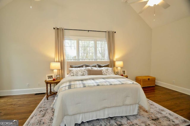 bedroom featuring baseboards, high vaulted ceiling, wood finished floors, and a ceiling fan