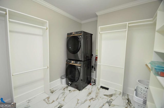 clothes washing area featuring marble finish floor, stacked washer and clothes dryer, ornamental molding, baseboards, and laundry area