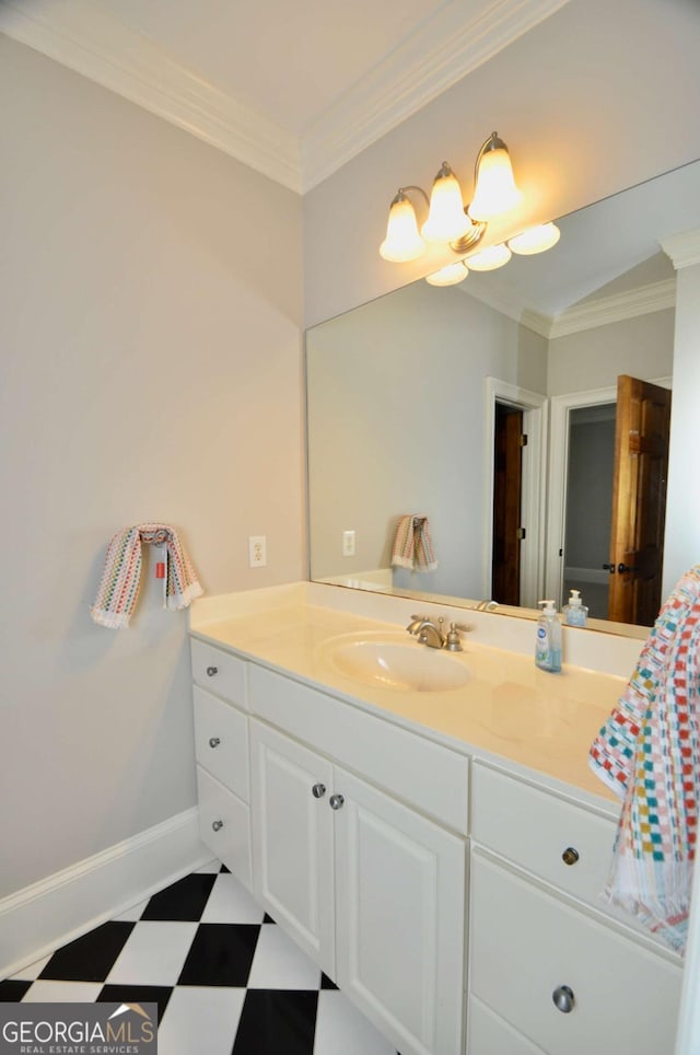 bathroom featuring tile patterned floors, vanity, crown molding, and baseboards