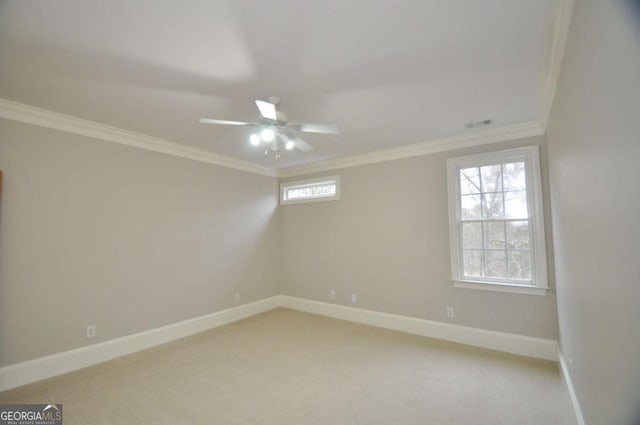 empty room with ceiling fan, baseboards, light carpet, and ornamental molding