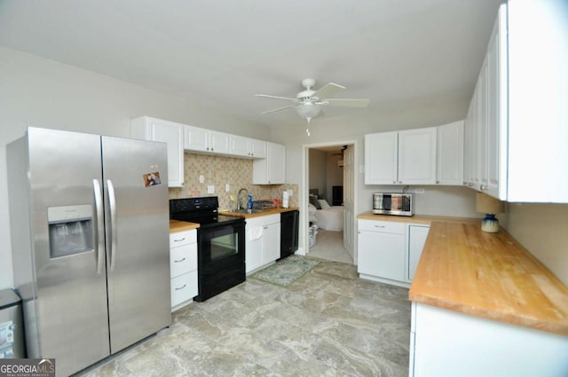 kitchen featuring ceiling fan, a sink, black appliances, white cabinetry, and backsplash