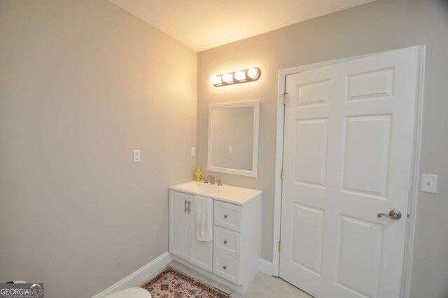 bathroom with baseboards and vanity