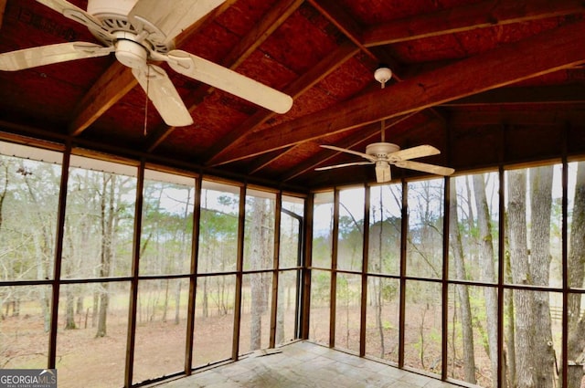 unfurnished sunroom featuring lofted ceiling and a ceiling fan