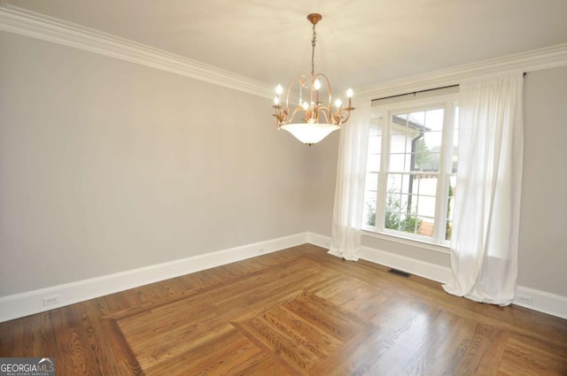 empty room with visible vents, baseboards, a notable chandelier, and crown molding