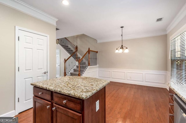 kitchen featuring a chandelier, stainless steel dishwasher, wood finished floors, and crown molding