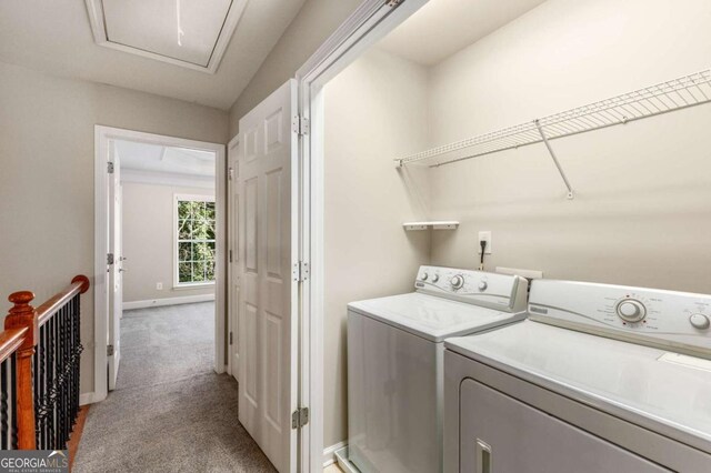 laundry room featuring baseboards, laundry area, attic access, washer and dryer, and light colored carpet