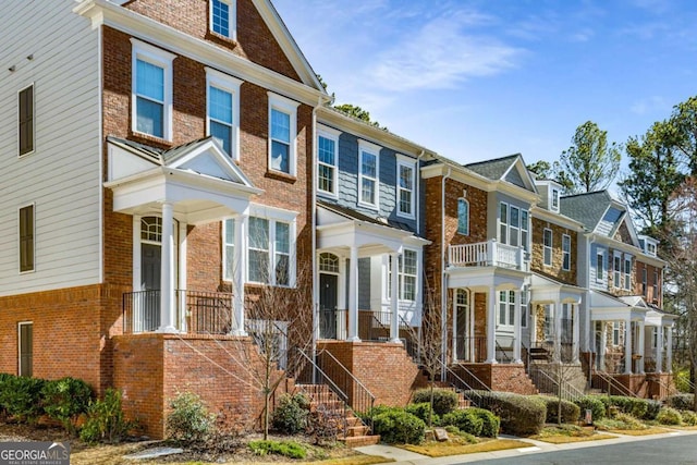 multi unit property with brick siding and a residential view