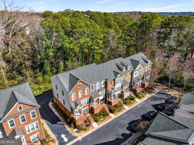 birds eye view of property with a forest view