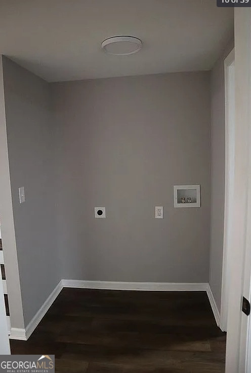 clothes washing area featuring dark wood-style floors, baseboards, hookup for an electric dryer, and hookup for a washing machine