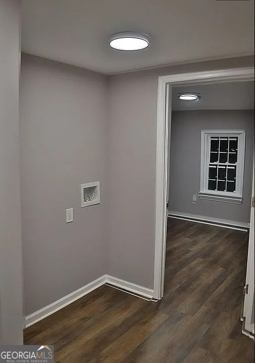 washroom with baseboards, washer hookup, and dark wood-style flooring