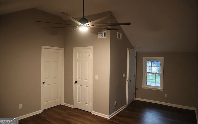 unfurnished bedroom featuring dark wood finished floors, visible vents, baseboards, and lofted ceiling