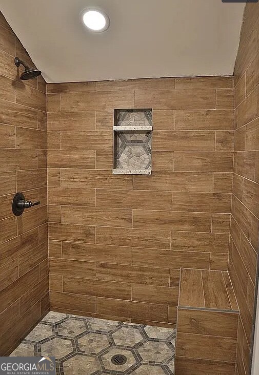 full bathroom with a tile shower