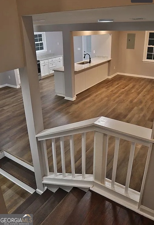 stairway featuring baseboards and wood finished floors