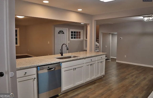 kitchen with light stone counters, dark wood-style flooring, a sink, white cabinets, and dishwasher