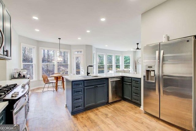 kitchen featuring light countertops, appliances with stainless steel finishes, and a sink