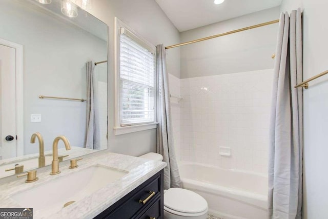 bathroom featuring vanity, toilet, and shower / tub combo