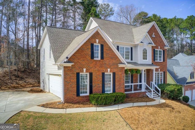 traditional home with concrete driveway, covered porch, brick siding, and roof with shingles