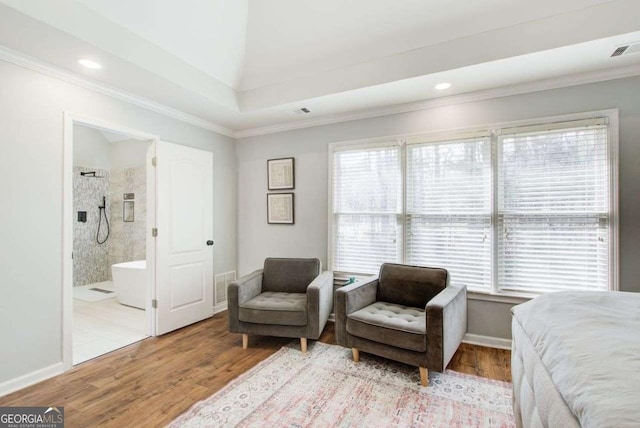 bedroom with visible vents, multiple windows, and wood finished floors