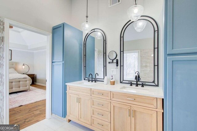 bathroom featuring double vanity, visible vents, ensuite bathroom, and a sink