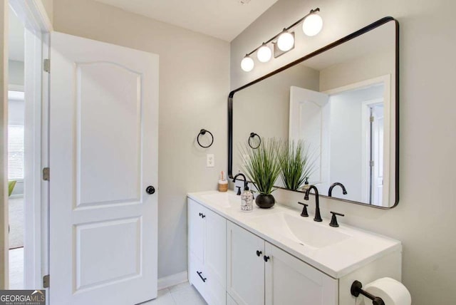 bathroom featuring a sink and double vanity