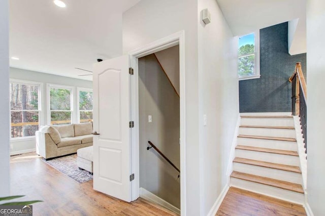 stairway featuring recessed lighting, baseboards, and wood finished floors