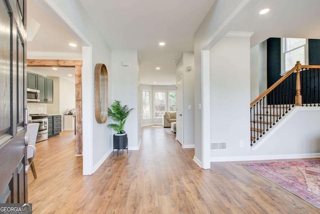 foyer entrance with visible vents, baseboards, stairs, light wood-type flooring, and recessed lighting