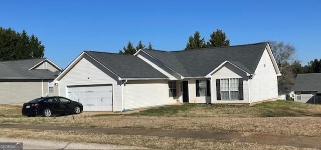 ranch-style house featuring a garage