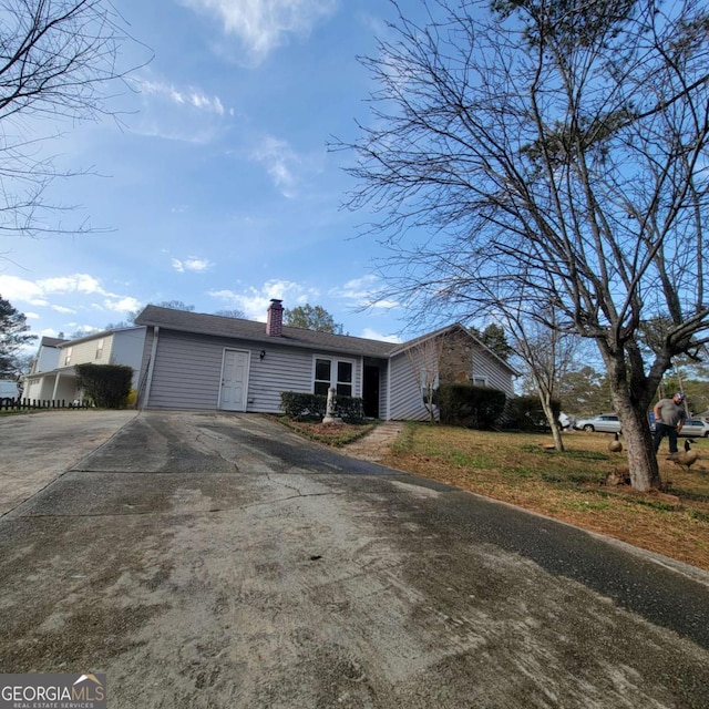 4906 Kellys Mill Dr NW, Lilburn, GA 30047 - single story home with concrete driveway and a chimney