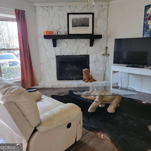 4906 Kellys Mill Dr NW, Lilburn, GA 30047 - living room with ornamental molding, a stone fireplace, and wood finished floors