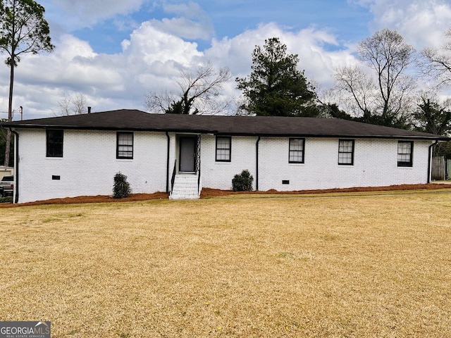 view of front of home featuring crawl space, brick siding, and a front lawn