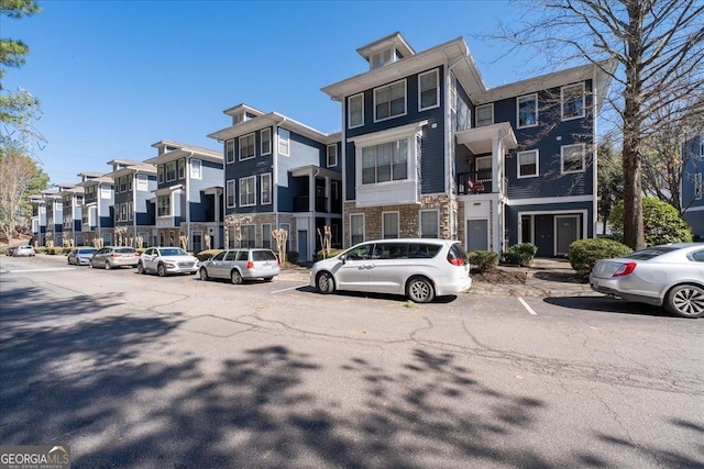 view of front of home featuring stone siding and a residential view