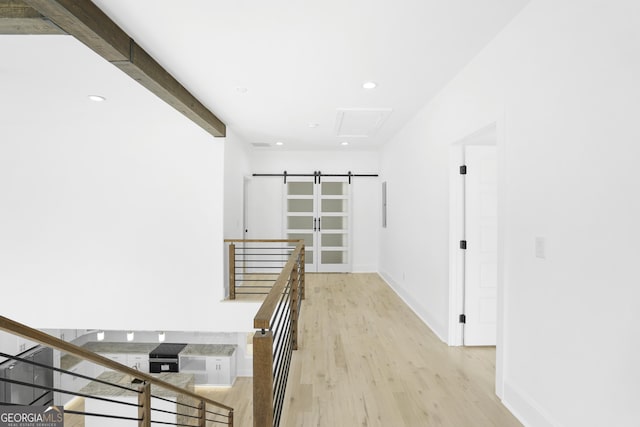 hall with baseboards, recessed lighting, light wood-style floors, beamed ceiling, and an upstairs landing