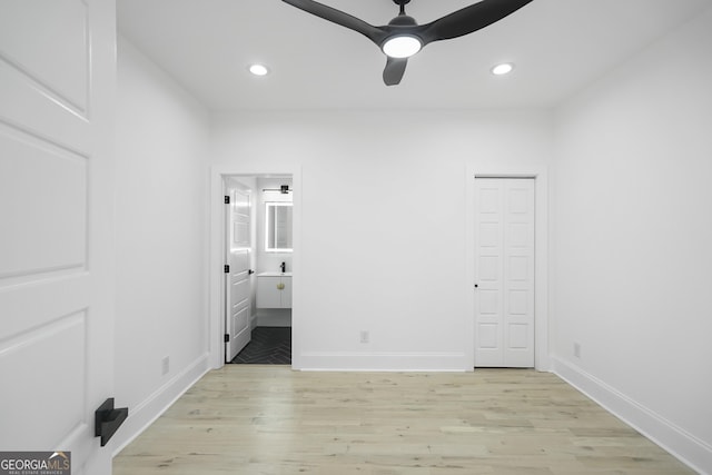 unfurnished bedroom with recessed lighting, ensuite bath, and light wood-style flooring