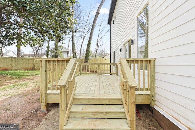 wooden terrace featuring fence