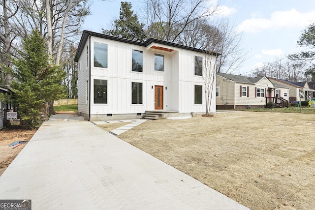 modern farmhouse featuring crawl space and board and batten siding